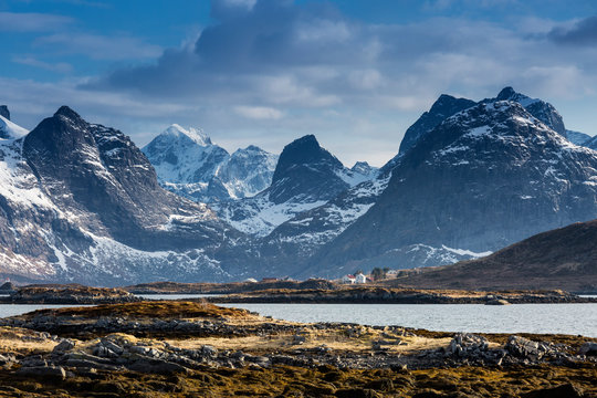 Snow on sunny, craggy mountains, Ramberg, Lofoten, Norway