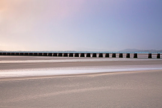 Tranquil pier over sandy estuary, Arnside Lancs, UK
