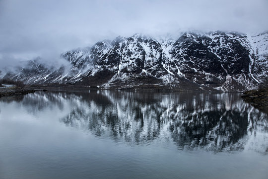 Fog over snowy, remote mountains water, Lia, Langoya, Vesteralen, Norway