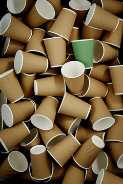 Full frame green recyclable coffee cup among disposable cups