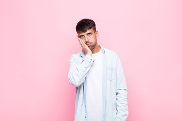 young handsome man feeling bored, frustrated and sleepy after a tiresome, dull and tedious task,...
