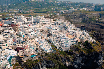 Naklejka premium Panoramic view on the Fira capital of Santorini at summer sun light