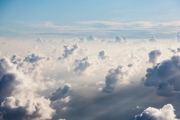 Aerial view fluffy white clouds in sunny, ethereal sky