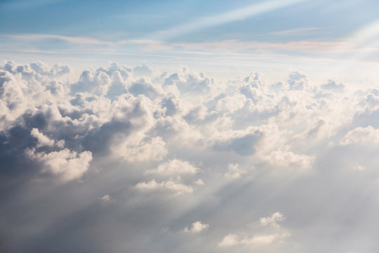 Aerial view sunbeams over fluffy white clouds - Powered by Adobe