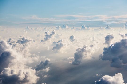 Aerial view fluffy white clouds in sunny, ethereal sky © Martin Barraud/Caia Image