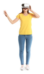 Young woman with virtual reality glasses on white background