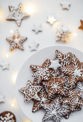 gingerbread cookie in the form of stars and snowflakes on a white background. painted with white glaze