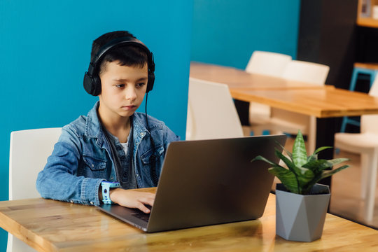 Gaming Video Games Computer Concept, Small Boy Playing Game With Headphones Enjoying Sitting At Modern Room.