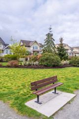 Bench in Park with residential background.