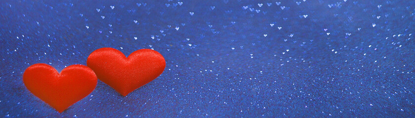 Two red hearts with bokeh lights background of classic blue color. , on a valentines day concept. Valentine's day banner.March 8, wedding, February 14 card, Valentine's day. Love concept. Copy space.