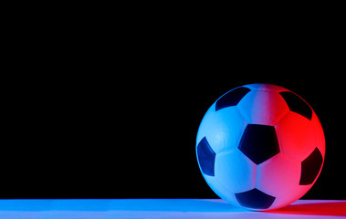 Fototapeta premium Soccer ball isolated on black background. Blue neon Banner Art concept