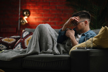 Obraz premium Sick man at home. Man taking medicine. 