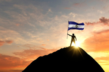 El Salvador flag being waved at the top of a mountain summit. 3D Rendering - obrazy, fototapety, plakaty
