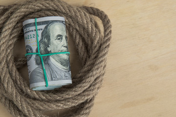 Hostage buyout concept image. Money dollars and rope