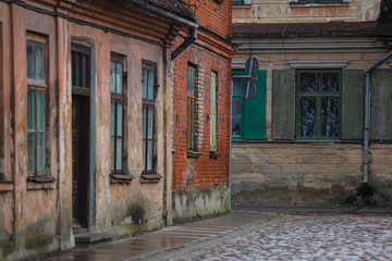 Fototapeta na wymiar View of old architecture houses on small brick countryside street.