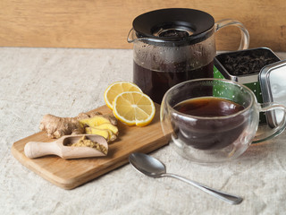 Hot tasty tea with lemon and ginger as a revitalizing warming agent, containing vitamins and substances that immunize the body