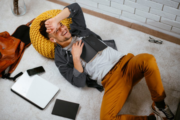 Young man having break from work and listens music. Businessman using smartphone.  Student listening music while studying.