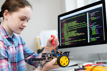 Female Pupil Building Robot Car In School Science Lesson