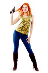 Portrait of beautiful redhead girl with gun on bright background