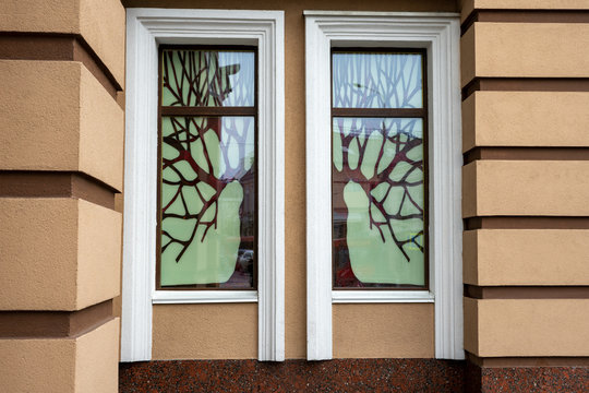 Large window with imitation stained glass in the form of a tree.
