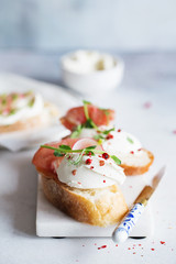 Bruschetta with prosciutto and cream cheese. Bread with smoked bacon and cream cheese. Toasted bread slice with meat and cream cheese
