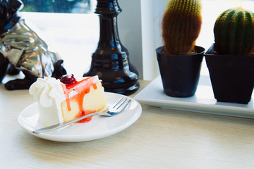 Slice cake with milk ice tea on wood table