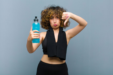young pretty sports woman wearing fitness clothes having an energy drink © kues1