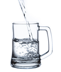 pouring water on a glass on white background clipping path