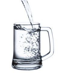 pouring water on a glass on white background clipping path