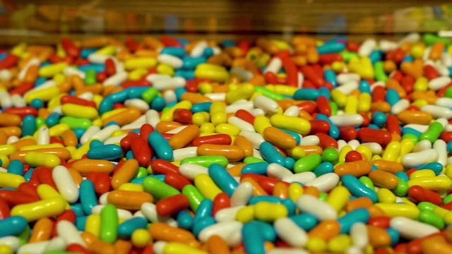 Close-up of a lot of colorful candies in the form of vitamins and tablets, delicious sweets in the pastry shop. Food dessert. 
