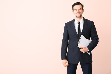 Male real estate agent on color background