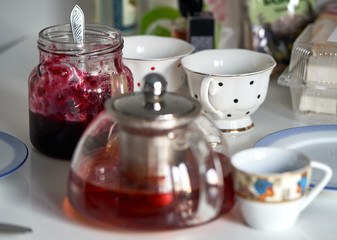 teapot with tea and a jar of jam