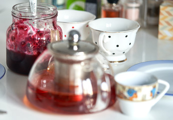 teapot with tea and a jar of jam