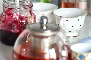 teapot with tea and a jar of jam