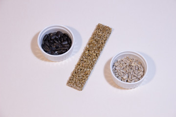 Energy bar made of sunflower seeds and honey on white background as percent icon