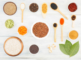 Ingredients for cooking rice: salt, allspice, cumin (jeera), chili, onion, masala, bay leaves, garlic, mustard seeds, carrot, fenugreek, cardamom, cloves. Healthy eating concept