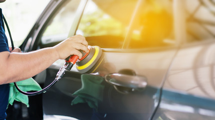 restore detailed cars: Polishing a car, Car care with power buffer machine at a service station,  Man with mechanically polished finishing