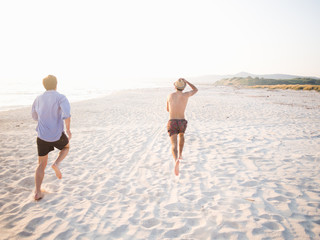 Friends running on the beach