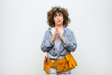 young housekeeper woman scheming and conspiring, thinking devious tricks and cheats, cunning and...