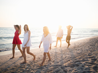 Friends running on the beach