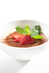 Italian Tiramisu Dessert with Green Fresh Mint and Sliced Strawberries