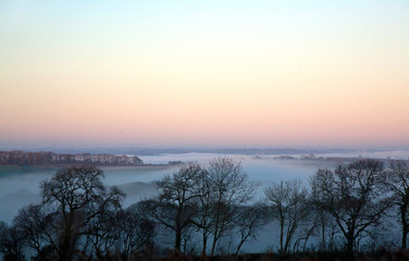 Fototapeta na wymiar Magical Mist over the rural countryside on a winter evening
