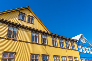 Fototapeta na wymiar Yellow Blue Corrugated Iron Houses Street Reykjavik Iceland