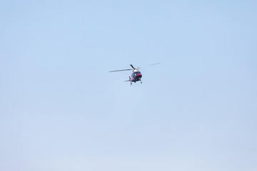 Small private helicopter on a background of blue sky