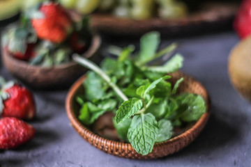 Photo of fresh mint leaves in a bowl. Mint and strawberry. Ingredients for summer cocktails and lemonade. Herb. Still life photography. Image