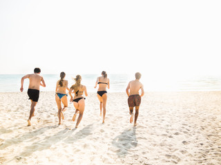Friends running on the beach