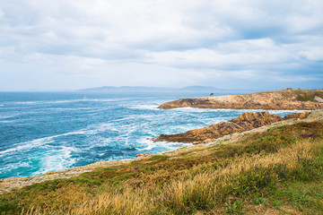 view of the Atlantic Ocean with the sculpture of the Caracola in the distance. A coruna, Spain
