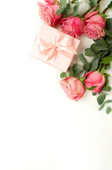 Bouquet of pink roses flowers, gift box  isolated on white background with copy space. Top view. flat lay