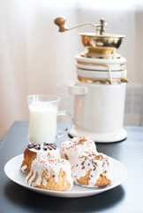 sweet muffins with sugar icing close-up on a white bowl