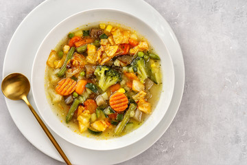Top view of vegetable soup on light background